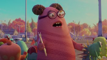 Movie still from “Monsters University” (2013), directed by Dan Scanlon – An animated character is holding a pen in one hand and an object in the other hand; Medium shot, Over the shoulder angle