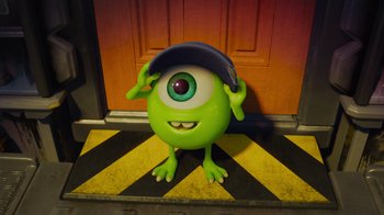 Movie still from “Monsters University” (2013), directed by Dan Scanlon – A green monster wearing a baseball cap and holding his hands on his head; Medium shot, Low angle