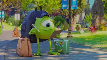 Movie still from “Monsters University” (2013), directed by Dan Scanlon – A green monster is standing next to some suitcases; Wide shot, Over the shoulder angle