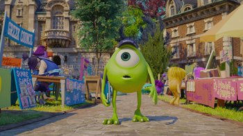 Movie still from “Monsters University” (2013), directed by Dan Scanlon – A green monster is standing on the sidewalk; Wide shot, Over the shoulder angle