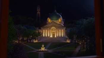 Movie still from “Monsters University” (2013), directed by Dan Scanlon – A large building with a fountain in front of it at night time; Extreme Wide shot, Low angle