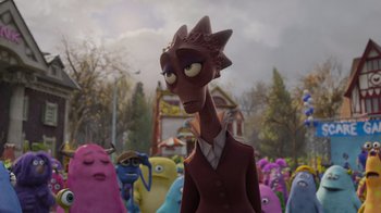 Movie still from “Monsters University” (2013), directed by Dan Scanlon – A group of people that are standing in the grass; Medium shot, Over the shoulder angle