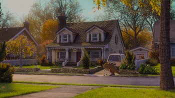 Movie still from “Monsters University” (2013), directed by Dan Scanlon – A car parked on the side of a road in front of a house; Extreme Wide shot, Over the shoulder angle