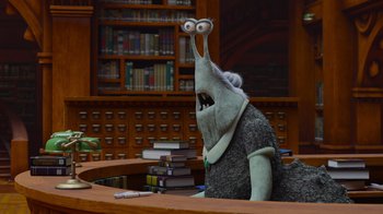Movie still from “Monsters University” (2013), directed by Dan Scanlon – A stuffed animal sitting at a desk in front of a book case; Medium shot, Over the shoulder angle