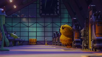Movie still from “Monsters University” (2013), directed by Dan Scanlon – A yellow monster standing in front of a row of chairs; Extreme Wide shot, Over the shoulder angle