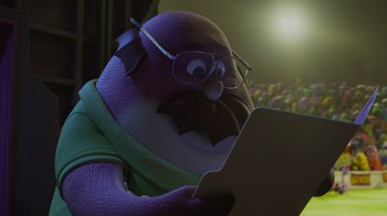 Movie still from “Monsters University” (2013), directed by Dan Scanlon – A cartoon character is reading a paper in front of a light; Close Up shot, Low angle