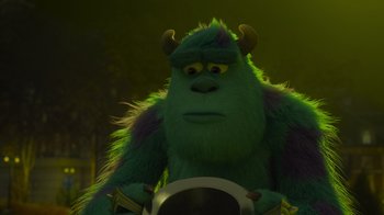 Movie still from “Monsters University” (2013), directed by Dan Scanlon – A green monster with horns is sitting on a motorcycle; Close Up shot, Low angle