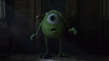 Movie still from “Monsters University” (2013), directed by Dan Scanlon – A green monster standing in front of a wooden door; Medium shot, Low angle