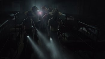 Movie still from “Monsters University” (2013), directed by Dan Scanlon – A group of people in a dark room with lights on them; Wide shot, Low angle