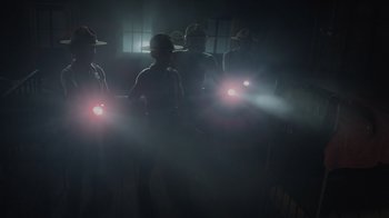 Movie still from “Monsters University” (2013), directed by Dan Scanlon – A group of people in a dark room holding lights; Wide shot, Low angle