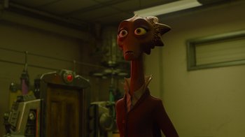 Movie still from “Monsters University” (2013), directed by Dan Scanlon – An animated character is standing in a dimly - lit room; Close Up shot, Over the shoulder angle