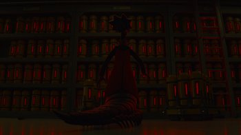 Movie still from “Monsters University” (2013), directed by Dan Scanlon – An image of an alien in front of a building; Wide shot, Low angle