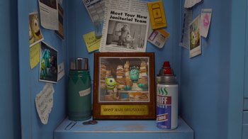Movie still from “Monsters University” (2013), directed by Dan Scanlon – A display case in a room filled with papers and other items; Medium shot, High angle