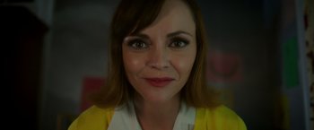 Movie still from “Monstrous” (2022), directed by Chris Sivertson – A woman's face in a yellow jacket; Close Up shot, Low angle