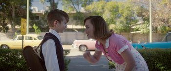 Movie still from “Monstrous” (2022), directed by Chris Sivertson – A woman and a young boy face each other in the street; Medium shot, Over the shoulder angle