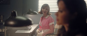 Movie still from “Monstrous” (2022), directed by Chris Sivertson – A woman sitting at a desk in front of a computer; Medium shot, Over the shoulder angle