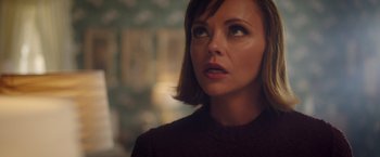 Movie still from “Monstrous” (2022), directed by Chris Sivertson – A person with short brown hair; Close Up shot, Over the shoulder angle