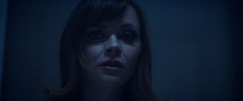 Movie still from “Monstrous” (2022), directed by Chris Sivertson – A person's face in the dark; Close Up shot, High angle