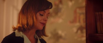 Movie still from “Monstrous” (2022), directed by Chris Sivertson – A person wearing a dress shirt; Close Up shot, Over the shoulder angle