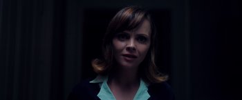Movie still from “Monstrous” (2022), directed by Chris Sivertson – A person wearing a jacket; Close Up shot, Over the shoulder angle