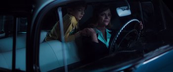 Movie still from “Monstrous” (2022), directed by Chris Sivertson – A woman and a boy sitting in a car; Medium shot, High angle
