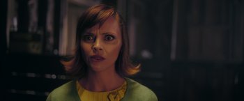 Movie still from “Monstrous” (2022), directed by Chris Sivertson – A person with short brown hair; Close Up shot, Over the shoulder angle