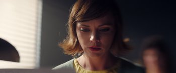 Movie still from “Monstrous” (2022), directed by Chris Sivertson – A person with short brown hair; Close Up shot, High angle
