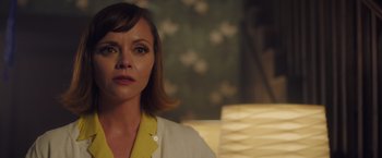 Movie still from “Monstrous” (2022), directed by Chris Sivertson – A person sitting in a room; Close Up shot, Over the shoulder angle