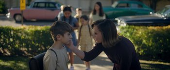 Movie still from “Monstrous” (2022), directed by Chris Sivertson – A woman touching the face of a young boy; Medium shot, Over the shoulder angle