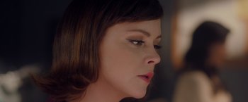 Movie still from “Monstrous” (2022), directed by Chris Sivertson – A woman's face in a dark room; Close Up shot, Over the shoulder angle