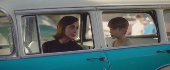 Movie still from “Monstrous” (2022), directed by Chris Sivertson – A woman and a boy in the back of a car; Medium shot, Over the shoulder angle