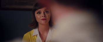 Movie still from “Monstrous” (2022), directed by Chris Sivertson – A person wearing a yellow shirt; Close Up shot, Over the shoulder angle