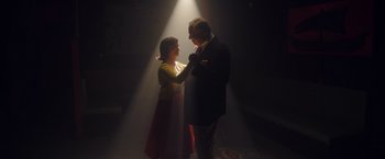 Movie still from “Monstrous” (2022), directed by Chris Sivertson – A man and a woman are dancing in the dark; Medium shot, Low angle