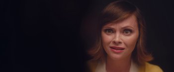 Movie still from “Monstrous” (2022), directed by Chris Sivertson – A woman's face in a dark room; Close Up shot, Over the shoulder angle