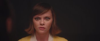 Movie still from “Monstrous” (2022), directed by Chris Sivertson – A person with short brown hair; Close Up shot, Over the shoulder angle