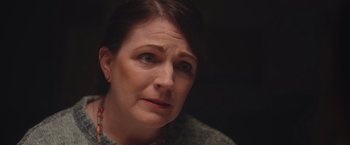 Movie still from “Monstrous” (2022), directed by Chris Sivertson – A person looking at the camera; Close Up shot, Over the shoulder angle