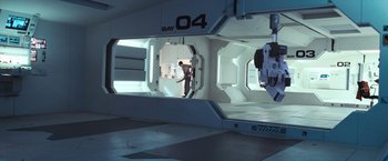 Movie still from “Moon” (2009), directed by Duncan Jones – A man standing inside of an empty space ship; Extreme Wide shot, Overhead angle