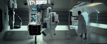 Movie still from “Moon” (2009), directed by Duncan Jones – An image of a room that has a lot of electronics in it; Wide shot, Overhead angle