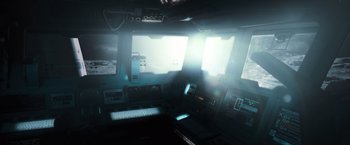 Movie still from “Moon” (2009), directed by Duncan Jones – A computer room with a computer keyboard and a monitor; Extreme Wide shot, High angle