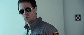 Movie still from “Moon” (2009), directed by Duncan Jones – A person wearing sunglasses and a jacket; Close Up shot, Low angle