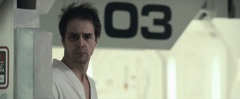 Movie still from “Moon” (2009), directed by Duncan Jones – A person in a white robe; Close Up shot, Low angle