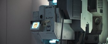 Movie still from “Moon” (2009), directed by Duncan Jones – A machine with a smiley face drawn on it; Extreme Close Up shot, Overhead angle