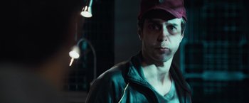 Movie still from “Moon” (2009), directed by Duncan Jones – A person wearing a hat; Close Up shot, Low angle