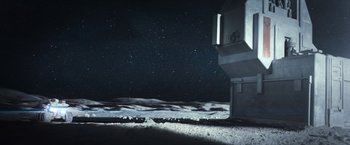 Movie still from “Moon” (2009), directed by Duncan Jones – A view of the moon from the side of a building; Extreme Wide shot, High angle