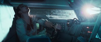 Movie still from “Moon” (2009), directed by Duncan Jones – A man is driving a car in the middle of the night; Close Up shot, Over the shoulder angle