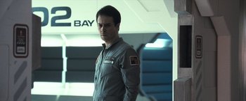 Movie still from “Moon” (2009), directed by Duncan Jones – A man standing in front of a wall; Close Up shot, Low angle