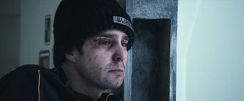 Movie still from “Moon” (2009), directed by Duncan Jones – A person wearing a hat; Close Up shot, Low angle