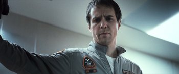 Movie still from “Moon” (2009), directed by Duncan Jones – A person wearing a uniform; Close Up shot, Low angle