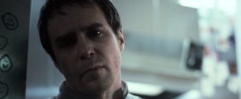 Movie still from “Moon” (2009), directed by Duncan Jones – A man's face in a car; Close Up shot, Over the shoulder angle