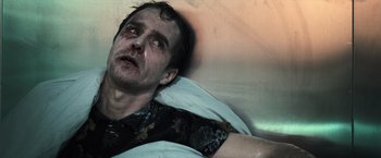 Movie still from “Moon” (2009), directed by Duncan Jones – A person laying in a bed; Close Up shot, Low angle